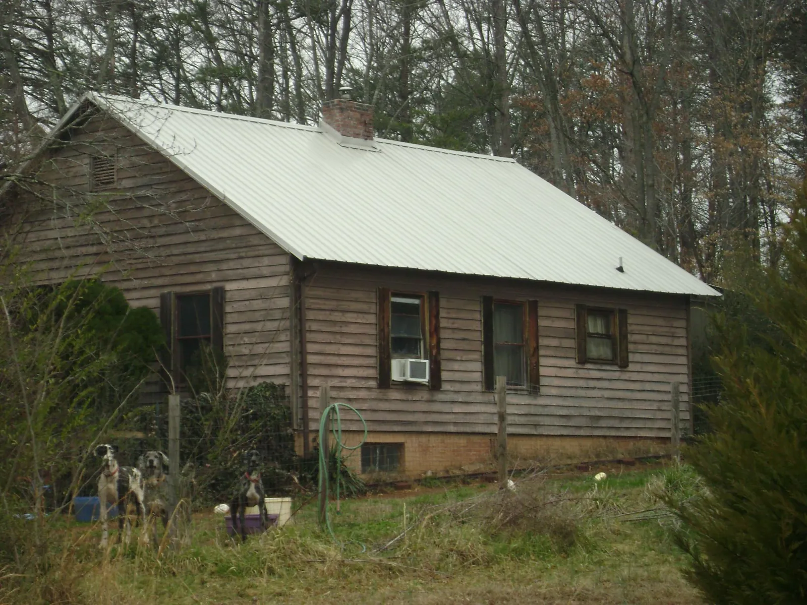 White metal roof on an old wood sided farmhouse, from a Metal Roof Installation job in Fawn Grove